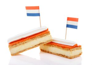 Traditional Dutch pastry called tompouce with flags